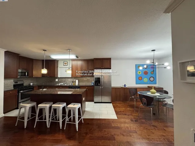 a large kitchen with a table and chairs