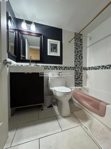 a bathroom with a sink toilet a mirror and bathtub