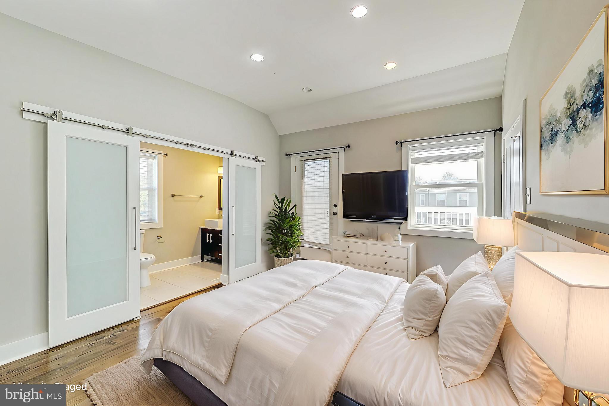 1330 Staples Street Northeast Washington, DC 20002 - Photo 18 of 64 a bedroom with a bed and a flat screen tv