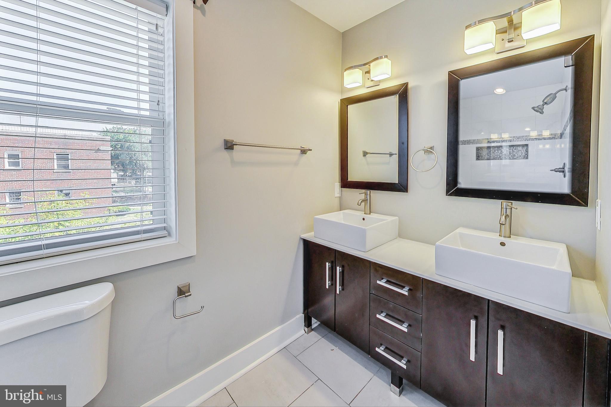 1330 Staples Street Northeast Washington, DC 20002 - Photo 23 of 64 a bathroom with a double vanity sink mirror and
