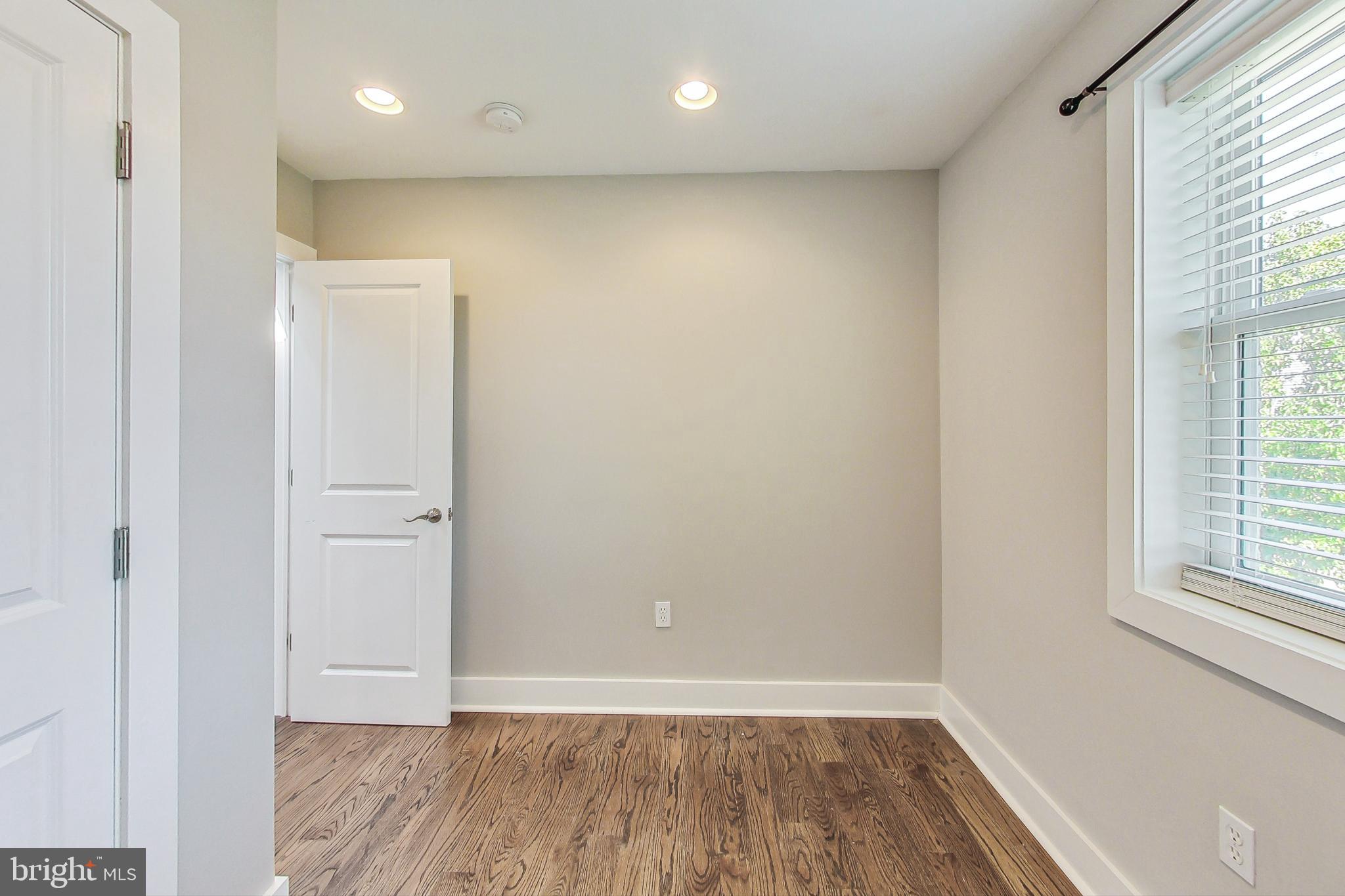 1330 Staples Street Northeast Washington, DC 20002 - Photo 29 of 64 an empty room with wooden floor and windows