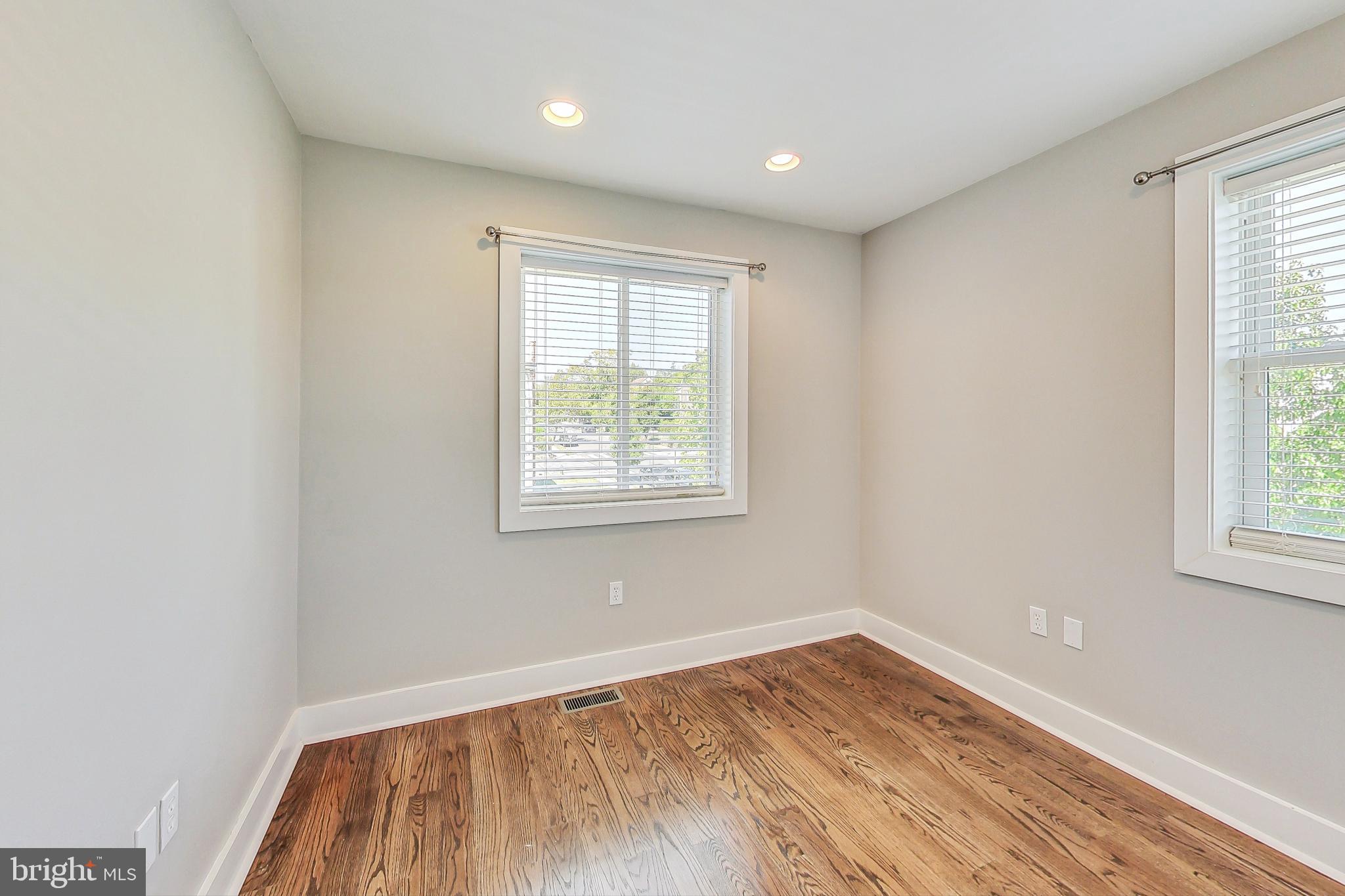 1330 Staples Street Northeast Washington, DC 20002 - Photo 31 of 64 an empty room with wooden floor and windows
