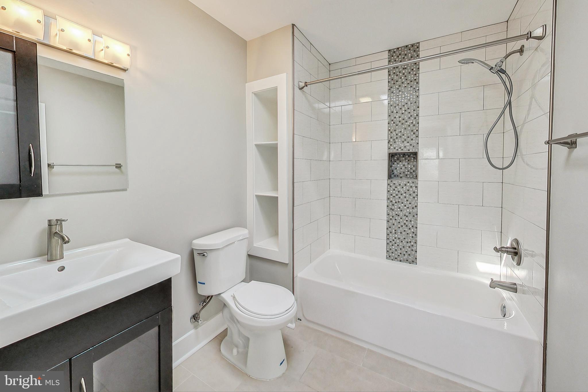 1330 Staples Street Northeast Washington, DC 20002 - Photo 36 of 64 a bathroom with a shower a toilet and a sink