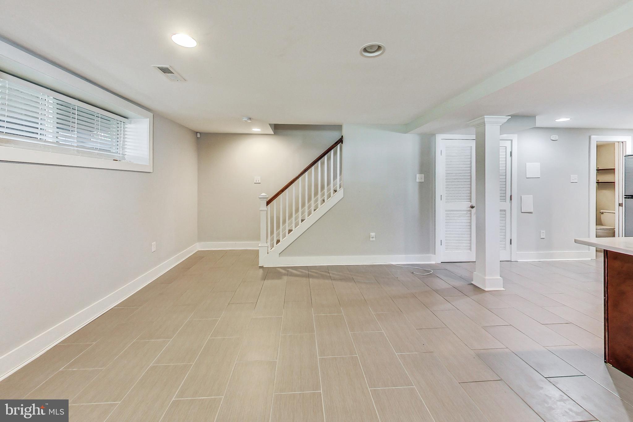 1330 Staples Street Northeast Washington, DC 20002 - Photo 41 of 64 a view of an empty room with wooden floor and a window