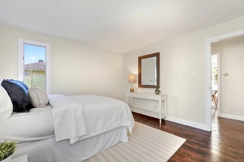 a bedroom with a bed and a dresser