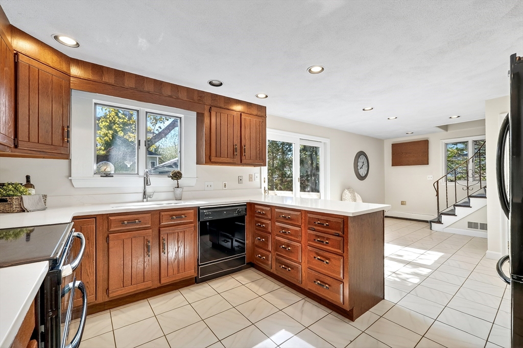 26 Garfield Road Melrose, MA 02176 - Photo 13 of 42 a kitchen with stainless steel appliances granite countertop a stove a sink and a microwave