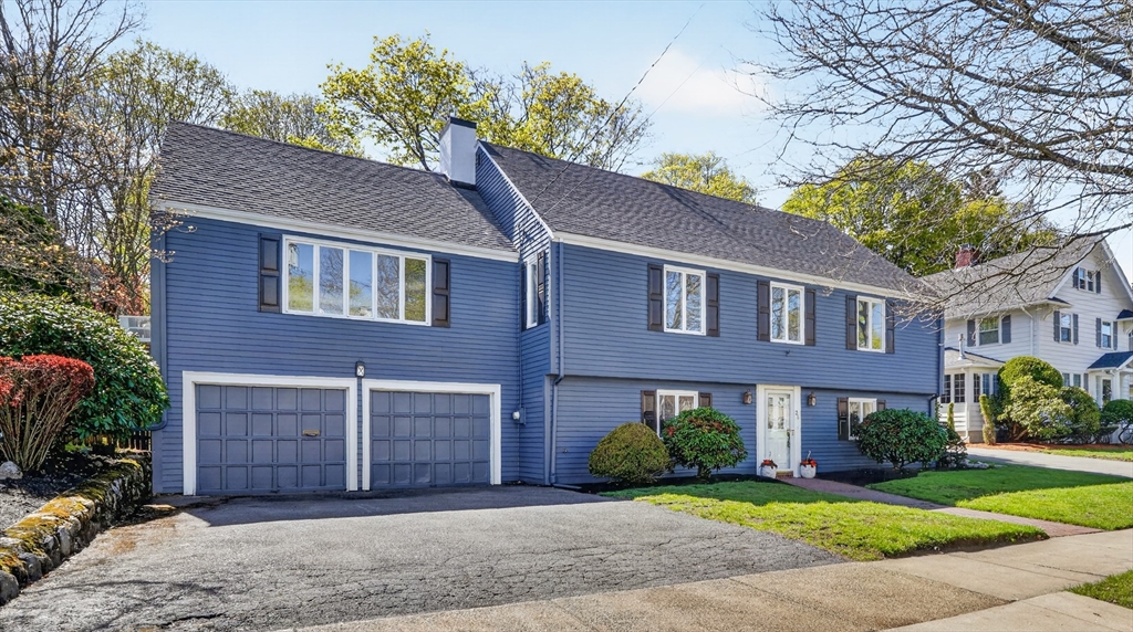 26 Garfield Road Melrose, MA 02176 - Photo 2 of 42 a view of a brick house with a yard plants and large tree