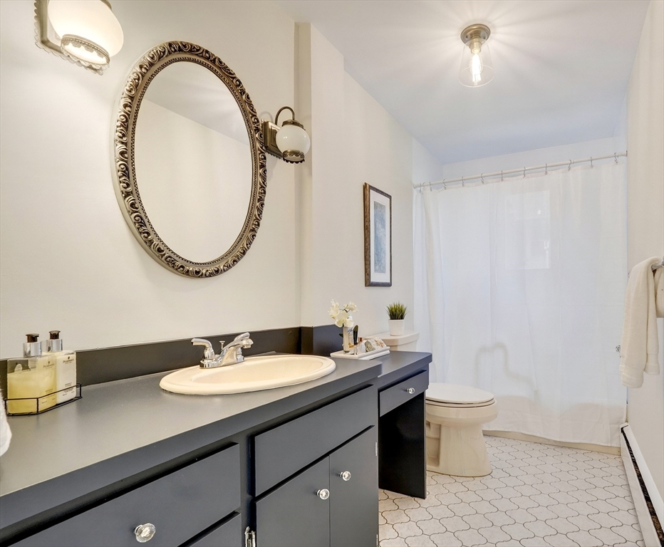 26 Garfield Road Melrose, MA 02176 - Photo 22 of 42 a bathroom with a granite countertop sink a toilet and a mirror