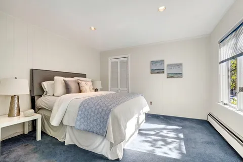 a spacious bedroom with a bed and a window