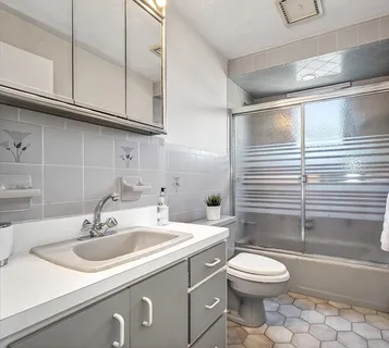 a bathroom with a sink a toilet and bathtub