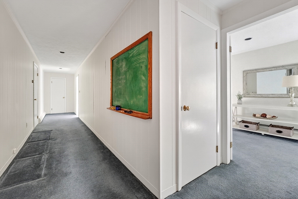 26 Garfield Road Melrose, MA 02176 - Photo 27 of 42 a view of a hallway and a livingroom with furniture