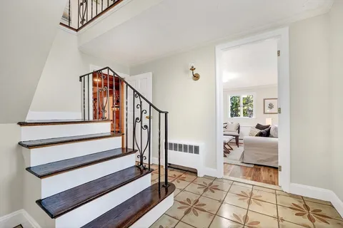 a view of entryway with bedroom and hall with wooden floor