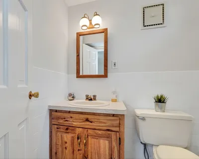 a bathroom with a toilet sink and mirror