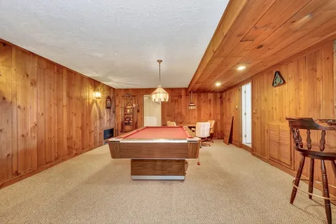 a room with pool table and windows