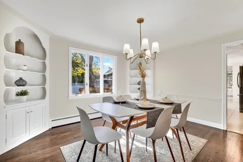 a view of a dining room with furniture wooden floor and chandelier