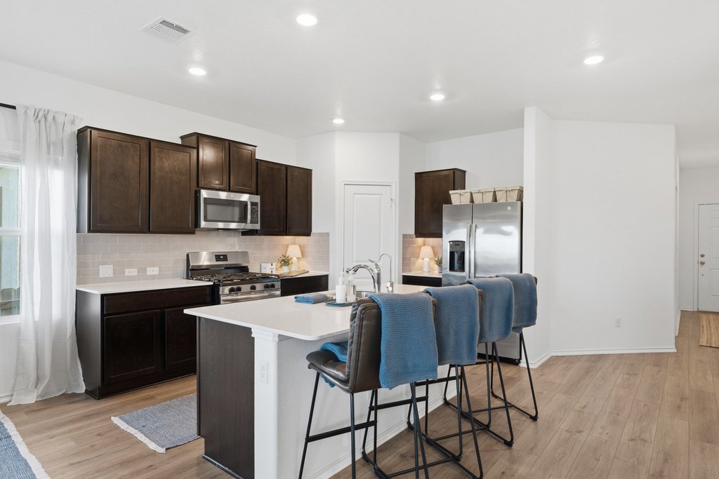 1233 Sweetspire Street Leander, TX 78641 - Photo 13 of 40 Culinary creations come to life in this kitchen, featuring an inviting island with seating.