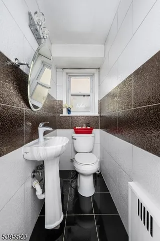 a bathroom with a sink toilet a mirror and bathtub