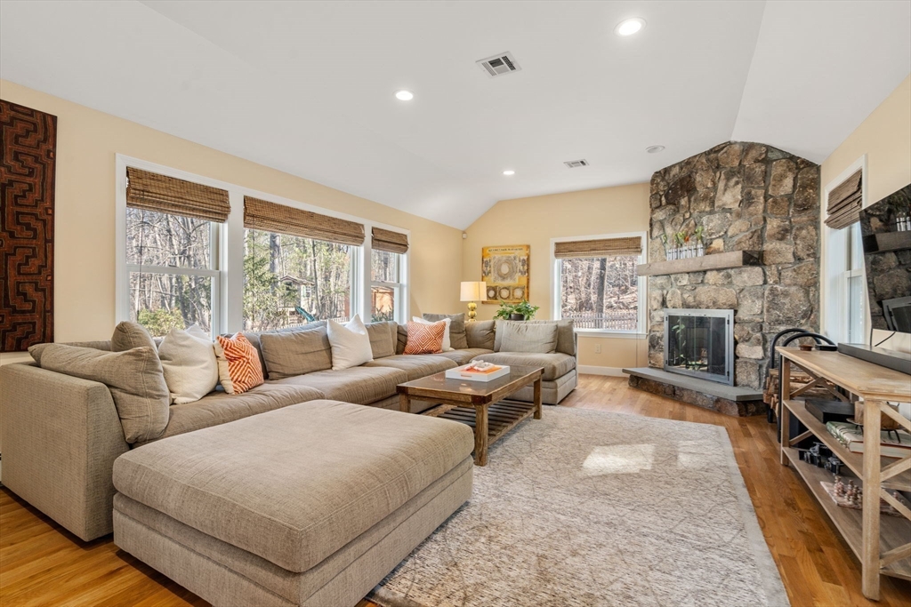 88 Robinwood Avenue Needham, MA 02492 - Photo 11 of 29 a living room with furniture a flat screen tv and a fireplace