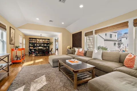 a living room with furniture a ceiling fan and a rug
