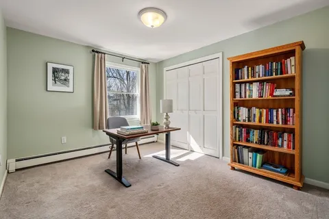 a living room with furniture and a book shelf