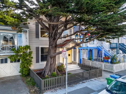 a front view of house with tree s