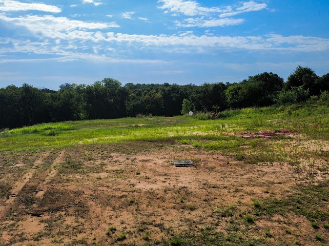 Pleasant Ridge Jones, OK 73049 - Photo 19 of 21 Expansive open parcel with varied terrain, featuring mature tree lines and a clear sky backdrop