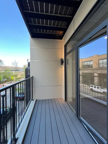 a view of a balcony with wooden floor