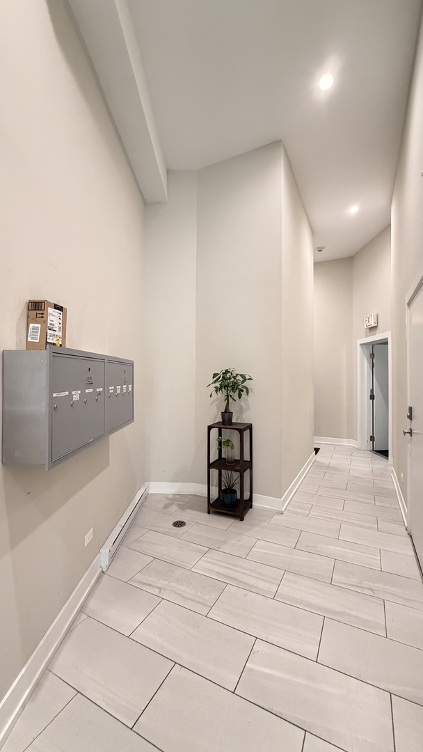 3244 North Lincoln Avenue, Unit 4 Chicago, IL 60657 - Photo 2 of 14 a bedroom with a bed and a potted plant