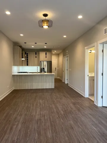 a view of a kitchen with a sink and a refrigerator