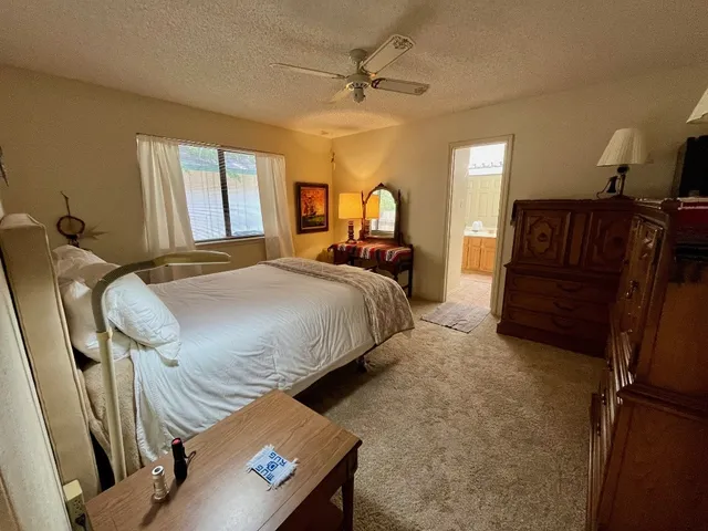 a bedroom with bed and window