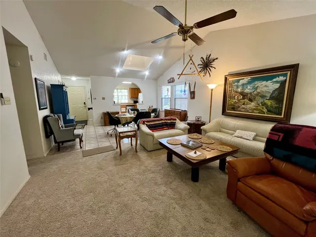 a living room with furniture a table and a flat screen tv