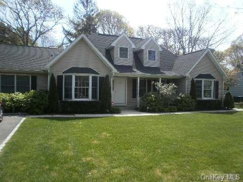 34 Wakeman Road Hampton Bays, NY 11946 - Photo 1 of 1 a front view of a house with a garden