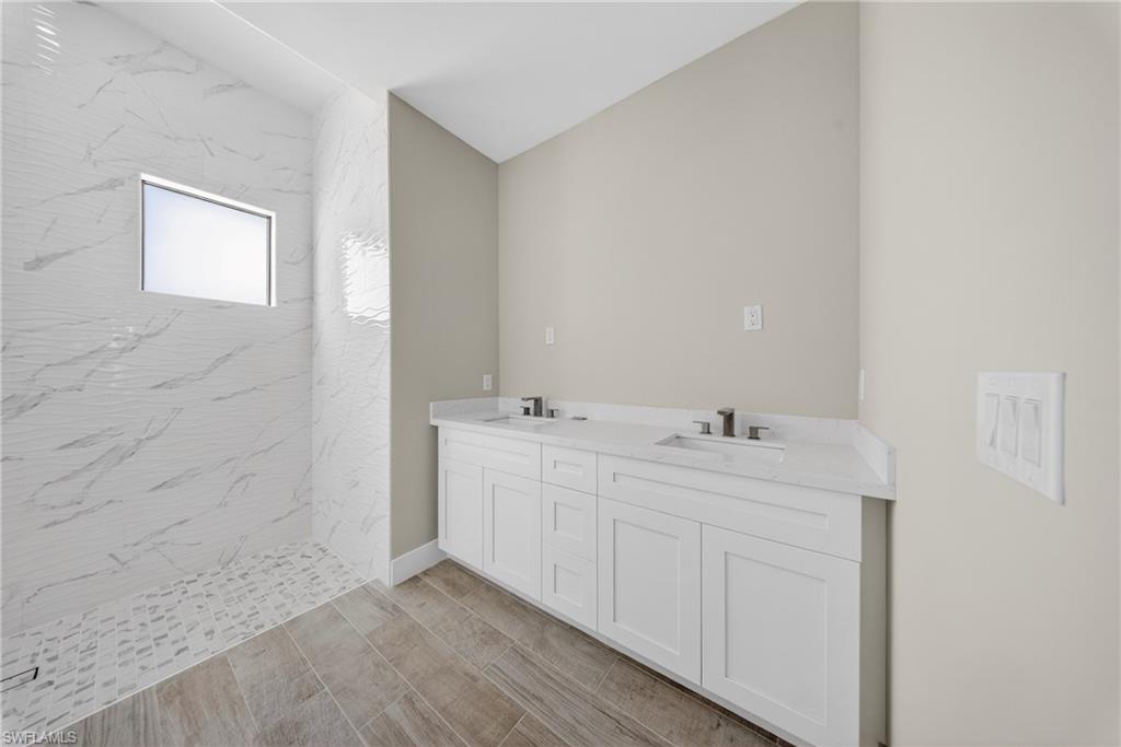 18 Scott Avenue Lehigh Acres, FL 33936 - Photo 24 of 37 a bathroom with 2 sink and a mirror