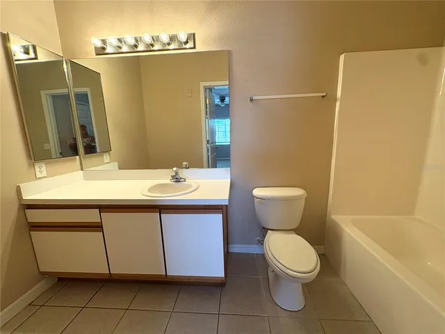 a bathroom with a sink mirror vanity and toilet
