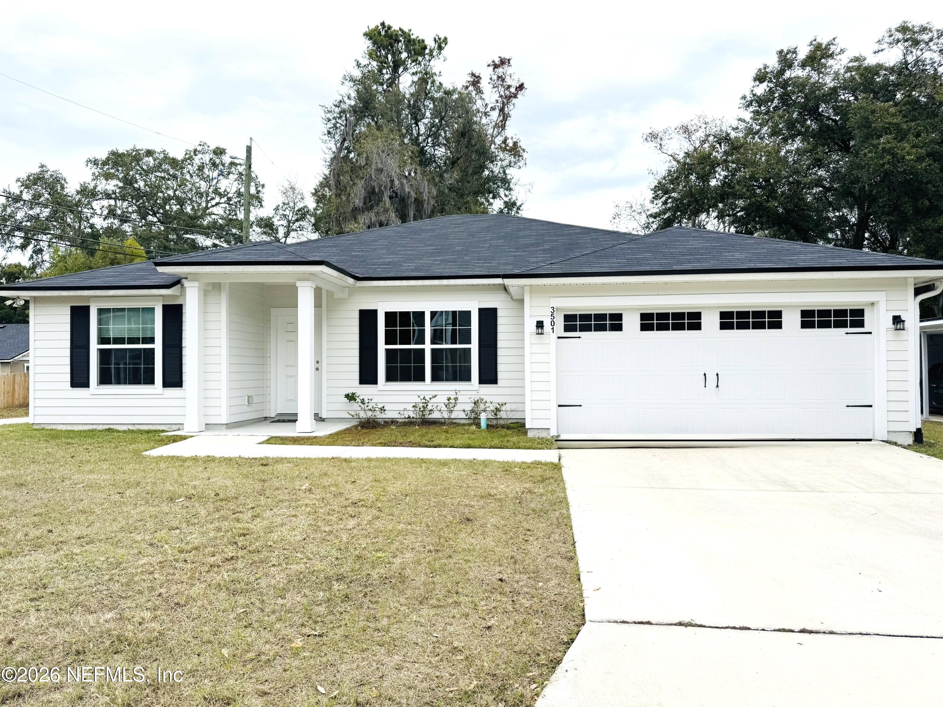a view of a big yard with an ocean view