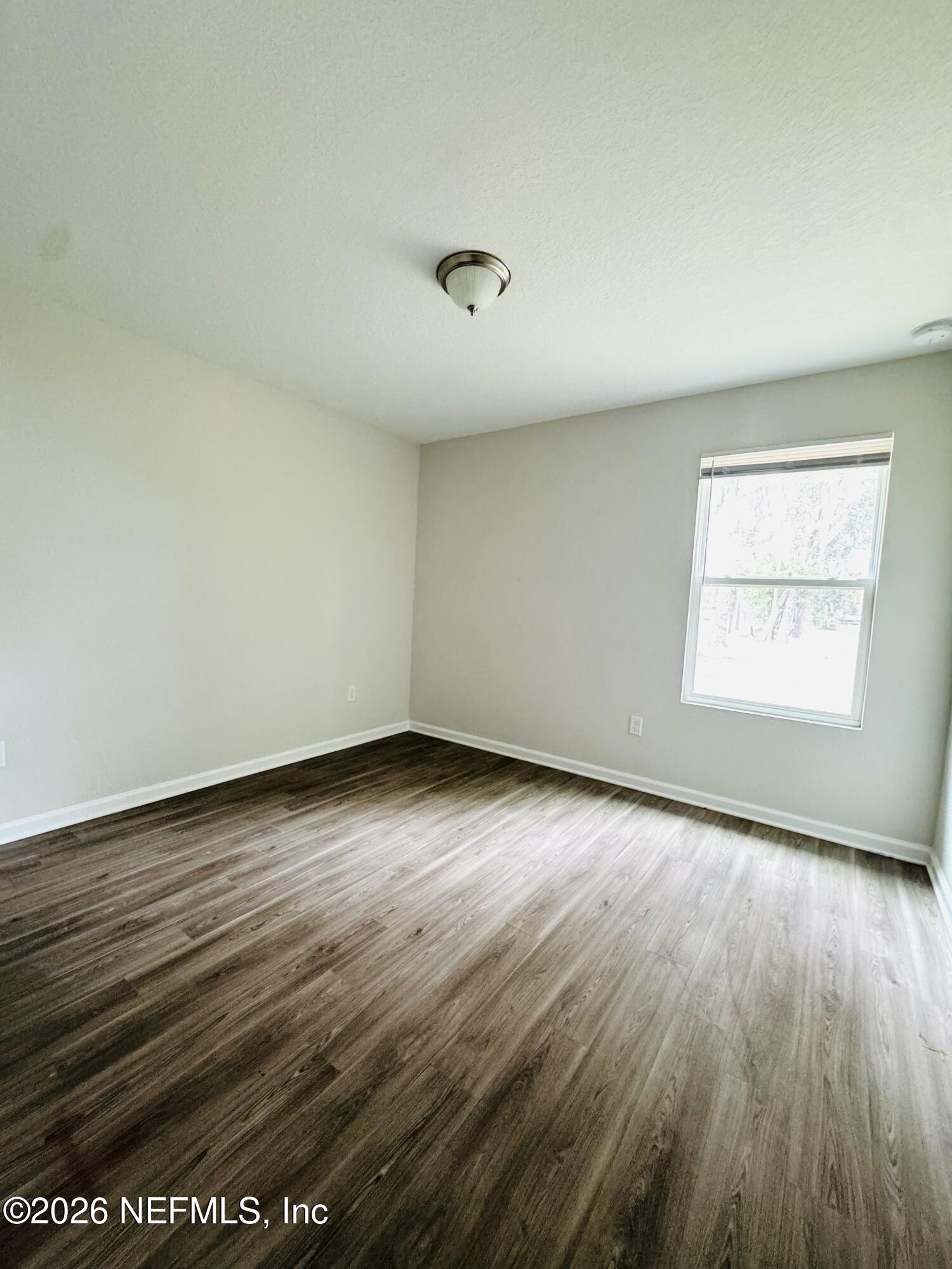 3501 Stillman Street Jacksonville, FL 32207 - Photo 11 of 17 an empty room with wooden floor and windows