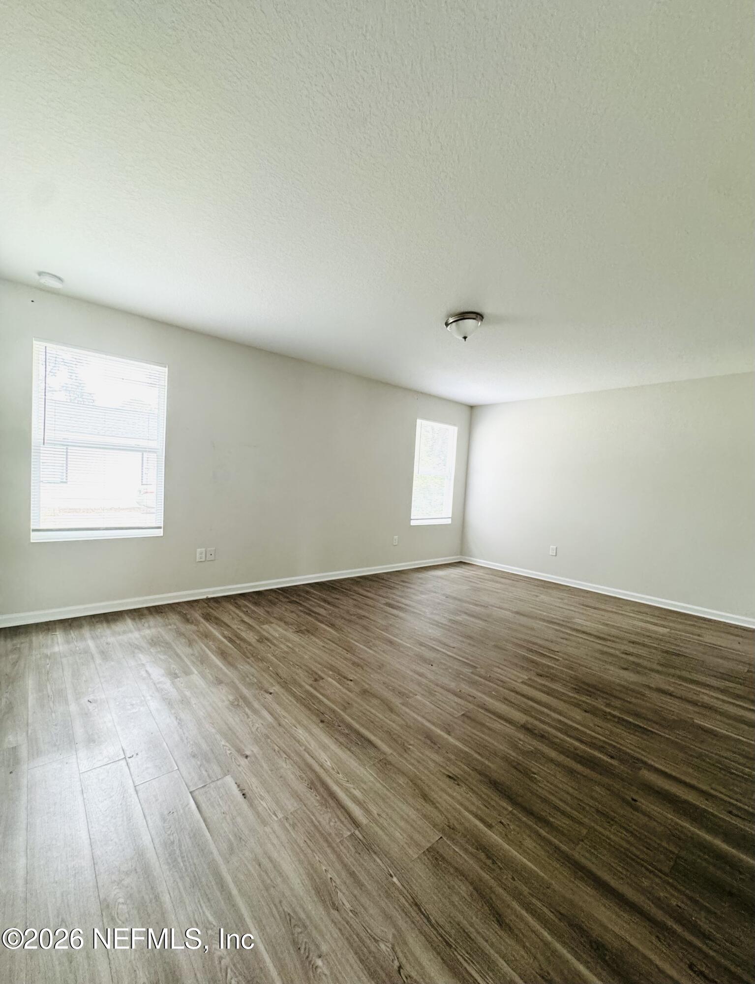 3501 Stillman Street Jacksonville, FL 32207 - Photo 14 of 17 an empty room with wooden floor and windows