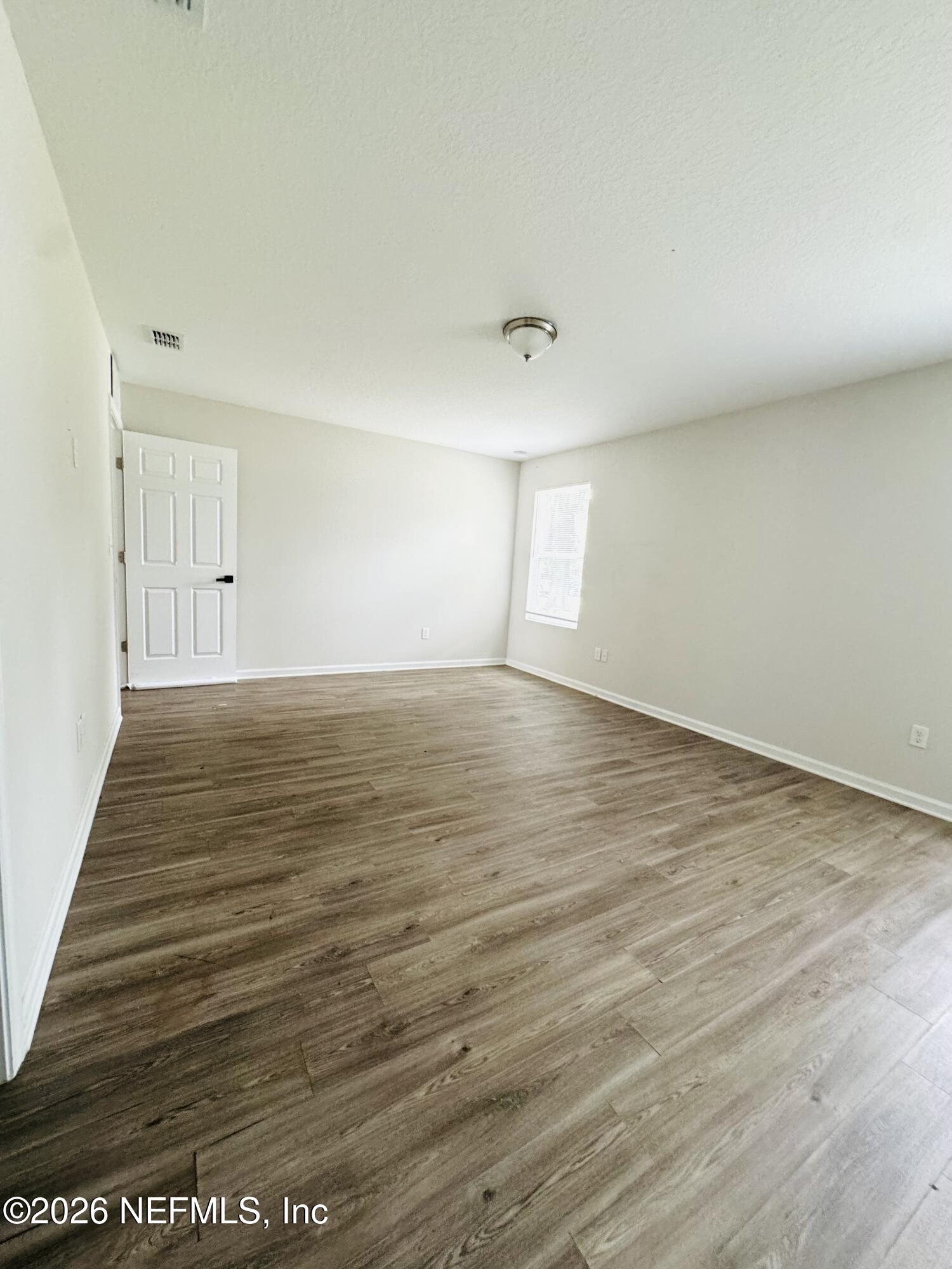 3501 Stillman Street Jacksonville, FL 32207 - Photo 15 of 17 a view of an empty room with wooden floor and a window