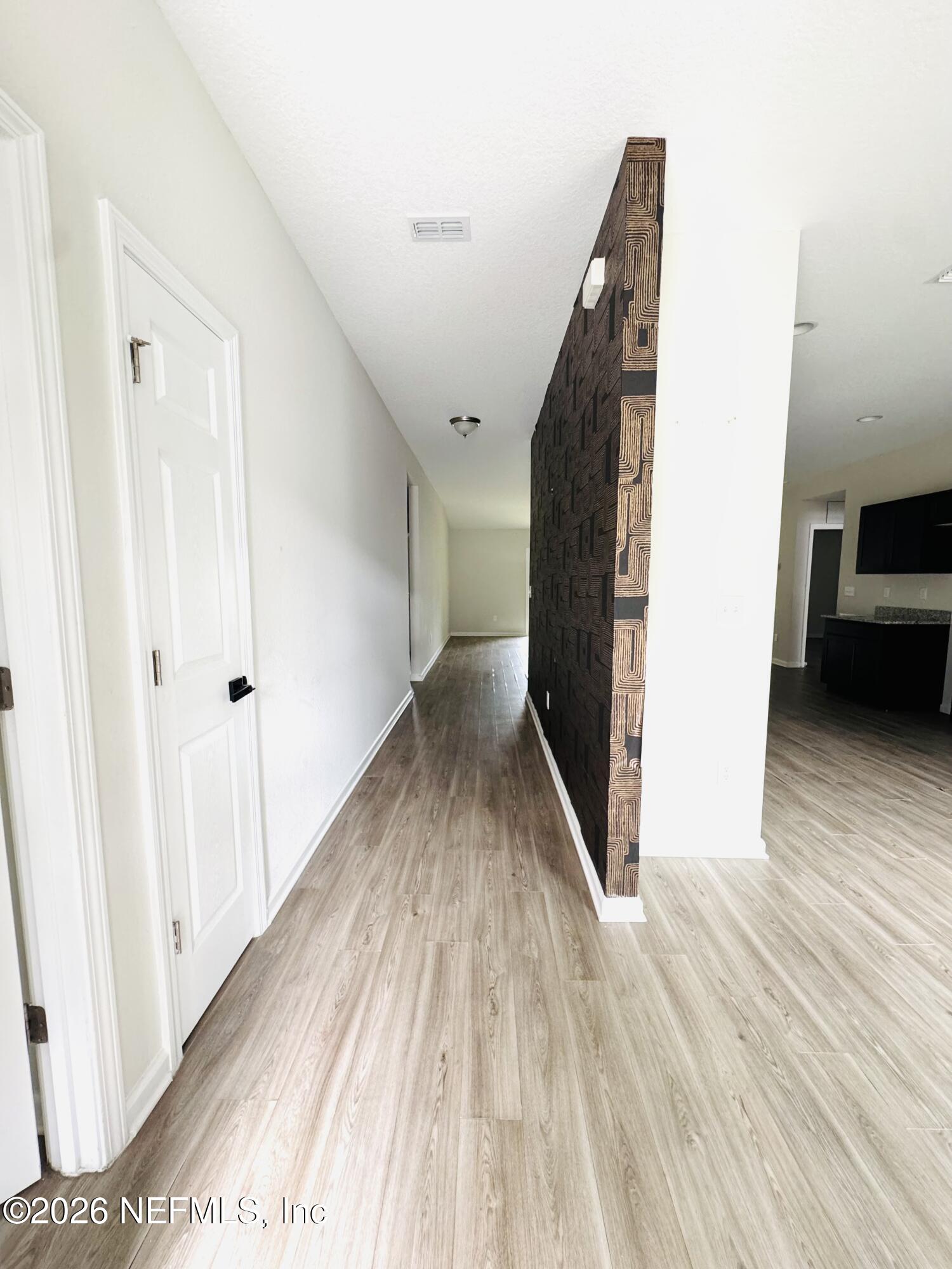 3501 Stillman Street Jacksonville, FL 32207 - Photo 2 of 17 a view of a hallway with wooden floor and stairs
