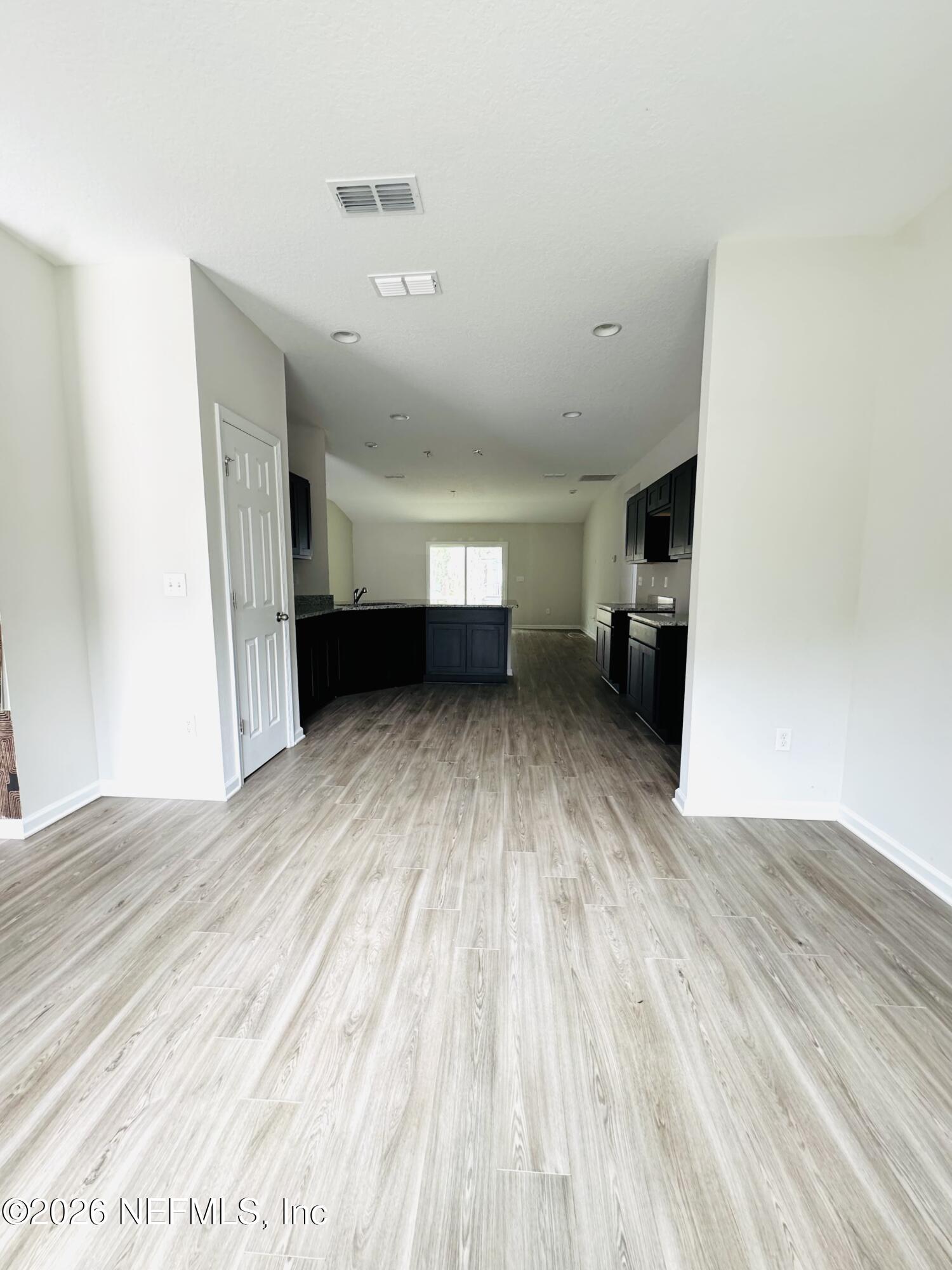 3501 Stillman Street Jacksonville, FL 32207 - Photo 5 of 17 a view of an empty room with wooden floor and a window