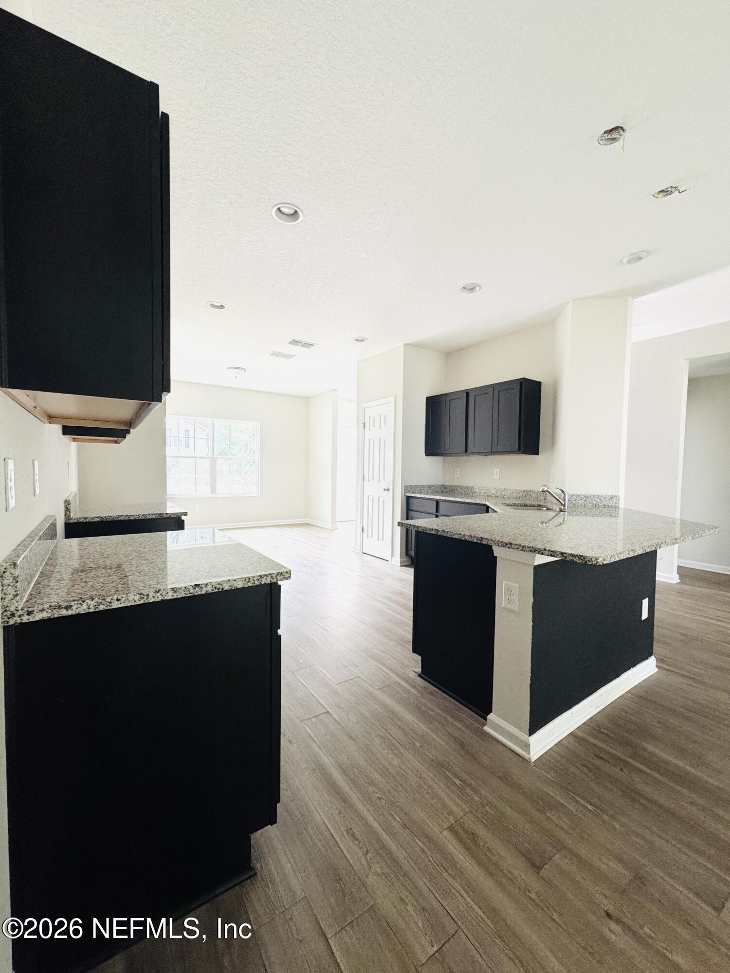 3501 Stillman Street Jacksonville, FL 32207 - Photo 7 of 17 a kitchen with stainless steel appliances kitchen island granite countertop a sink and a microwave
