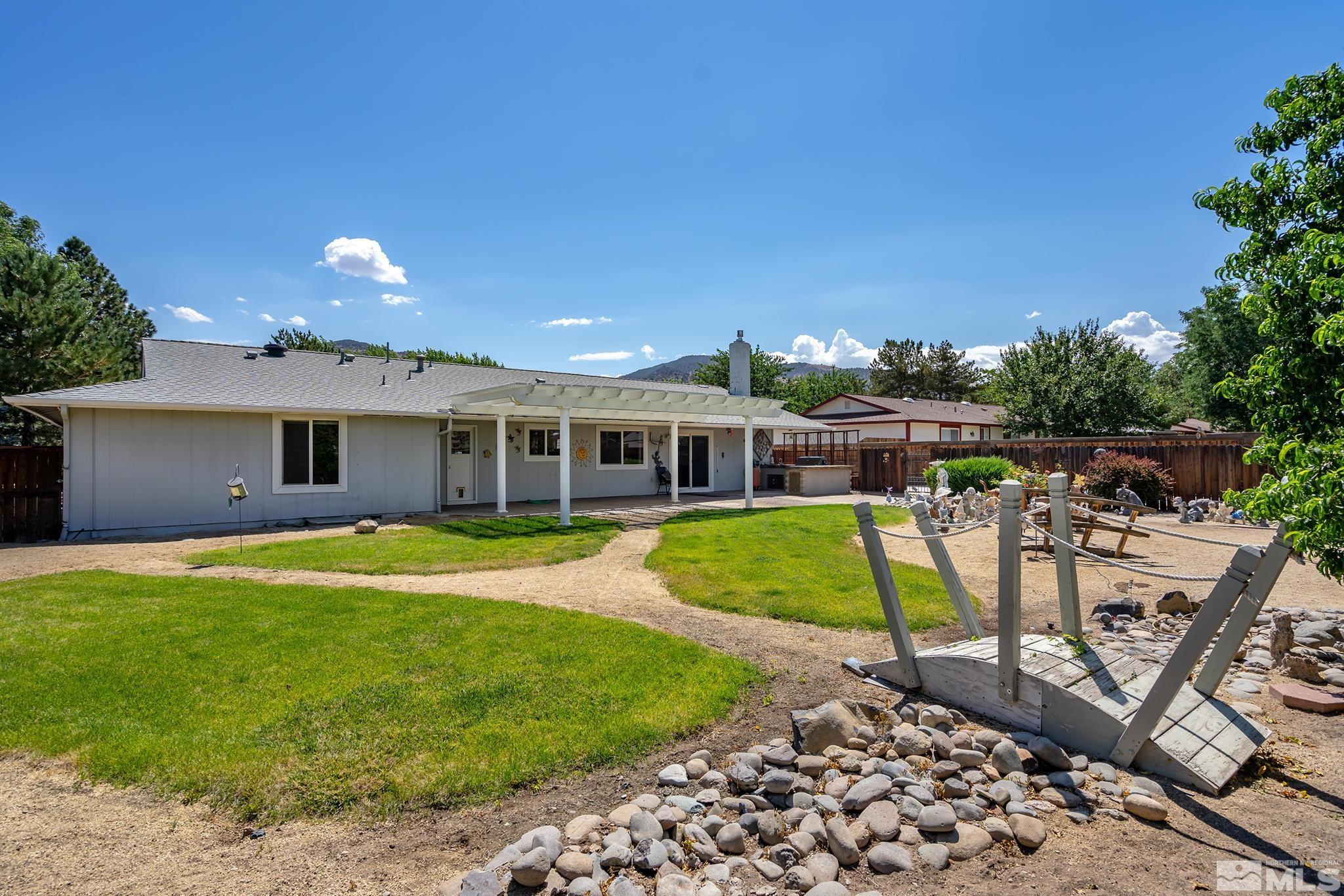 14335 Riata Circle Reno, NV 89521 - Photo 23 of 34 a view of a house with swimming pool and a yard