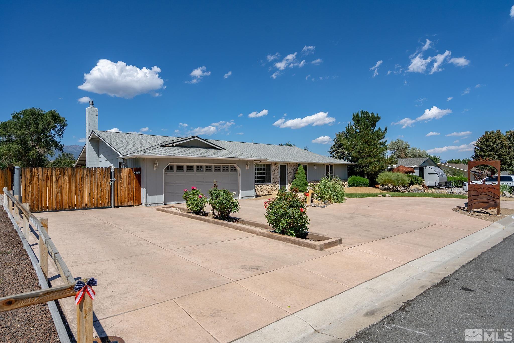 14335 Riata Circle Reno, NV 89521 - Photo 3 of 34 a front view of a house with a yard and a garage