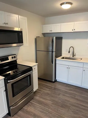 a kitchen with a sink appliances and cabinets