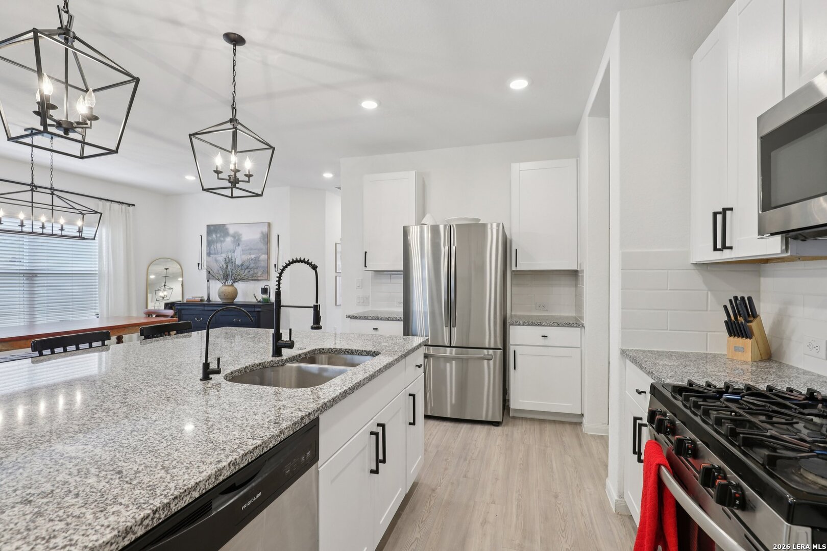 9062 Austin Seguin, TX 78155 - Photo 12 of 43 a kitchen with stainless steel appliances granite countertop a sink a stove and a refrigerator