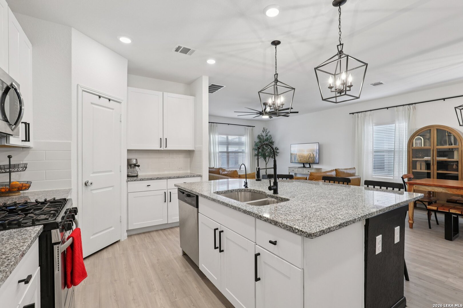 9062 Austin Seguin, TX 78155 - Photo 13 of 43 a kitchen with stainless steel appliances granite countertop a sink a stove and a wooden floors
