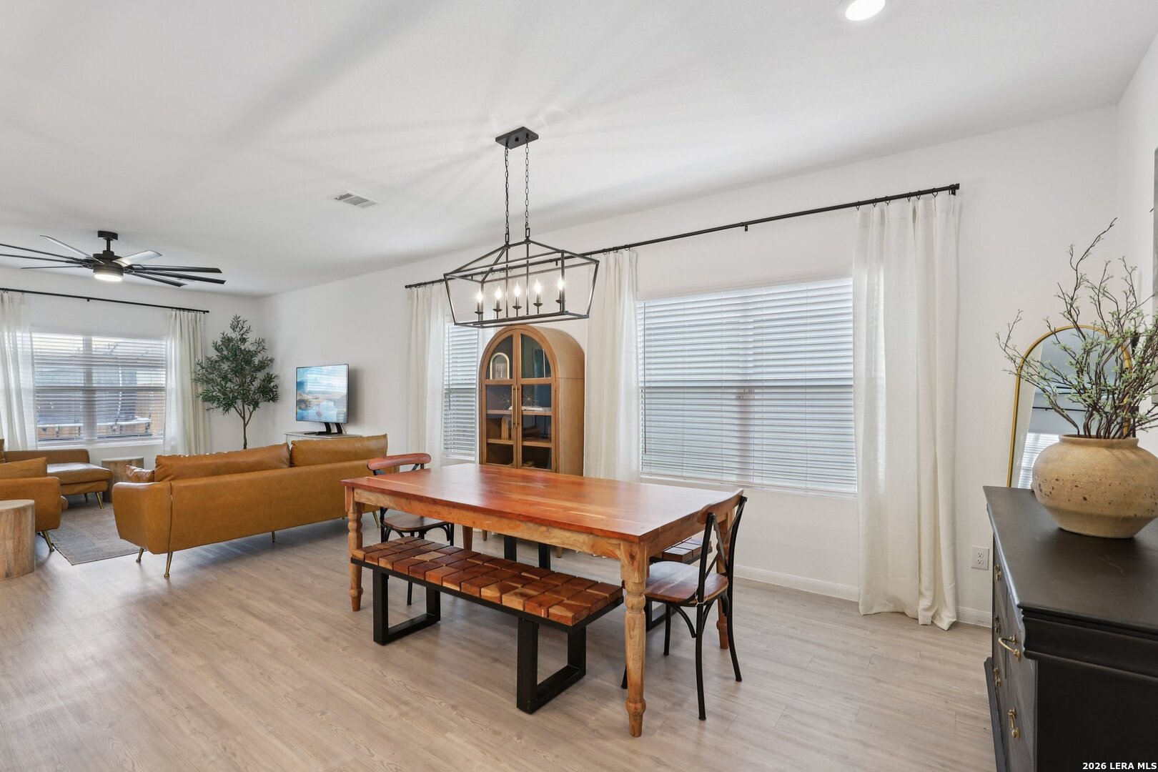 9062 Austin Seguin, TX 78155 - Photo 9 of 43 a dining room with furniture a chandelier and wooden floor