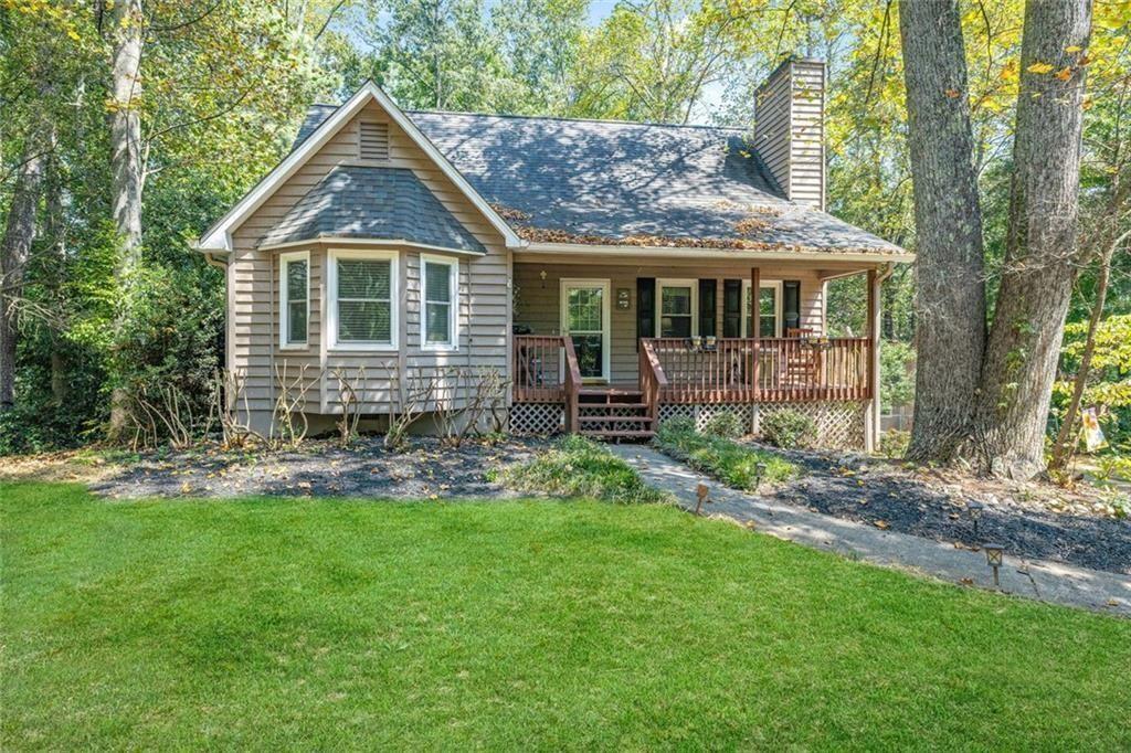 a front view of a house with a yard and porch