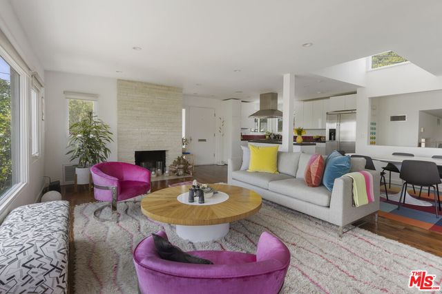 a kitchen with stainless steel appliances granite countertop a sink a stove cabinets counter top space and a window