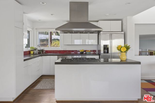 a kitchen with stainless steel appliances a sink stove and refrigerator